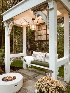 a white gazebo sitting next to a fire pit