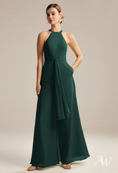 a woman in a long green dress with a bow at the waist and neckline