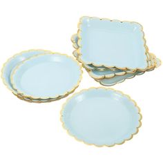 four blue and gold plates with scalloped edges