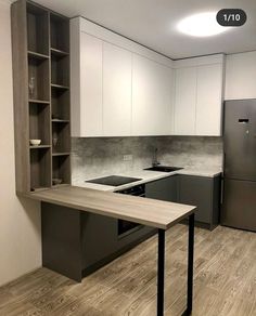 an empty kitchen with stainless steel appliances and white cabinets is pictured in this image from the front view