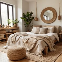 a bedroom with a bed, mirror and potted plant