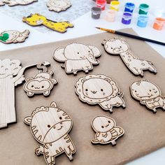 wooden cutouts of different animals on a table