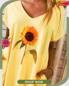 a woman wearing a yellow shirt with a sunflower painted on the front and side