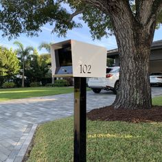 a mailbox in front of a large tree