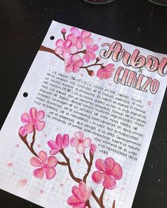 a piece of paper with pink flowers painted on it and writing in the bottom right corner