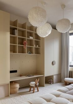 a bedroom with white furniture and hanging lights