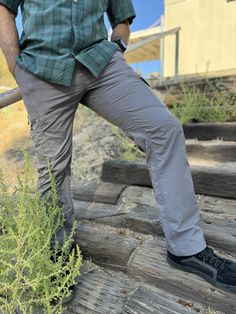 a man standing on some steps with his legs crossed