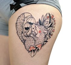 a woman's thigh with an image of two foxes in the shape of a heart