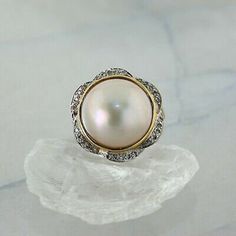 14K Yellow Gold Mabe Pearl and Diamond Cocktail Ring, large 14.7 mm pearl center, gold bezel, diamond halo, floral design, Ring size 6.75, 7.2 grams Stock # R00042A This listing contains photographs of the actual item you will receive. Our items are in excellent condition with little or no signs of wear and many are one of a kind pre-owned estate finds. Please look closely at the pictures in this listing as they are part of the product description. Please read the description, as any imperfectio Diamond Cocktail Ring, Mabe Pearl, Diamond Cocktail Rings, Fine Jewelry Designers, Bezel Diamond, Multi Stone Ring, Diamond Halo, Wedding Saving, Multi Stone