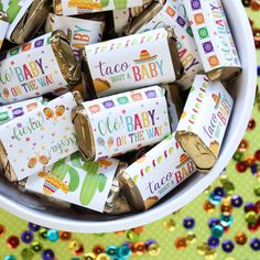 a bowl filled with lots of candy bar wrappers