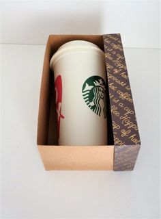 a starbucks coffee cup in a cardboard box