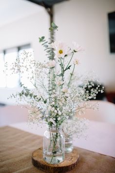 a vase filled with white flowers sitting on top of a table