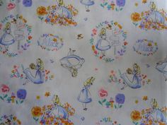 the fabric is very colorful and has little cartoon characters on it, including princesses