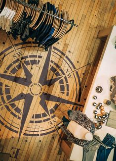 an overhead view of clothing and shoes on display in a room with wood flooring