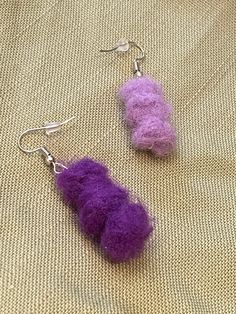 two pieces of purple wool are hanging from silver earwires