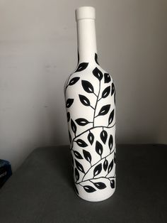 a black and white vase sitting on top of a table