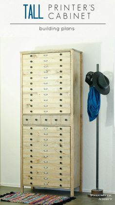 a tall wooden cabinet sitting next to a hat rack