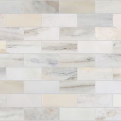 a white marble tile wall that looks like it is made out of different types of tiles