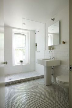 a bathroom with a sink, toilet and window