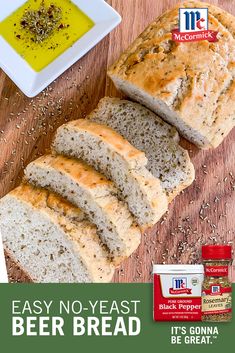 a loaf of beer bread with butter and seasoning next to it