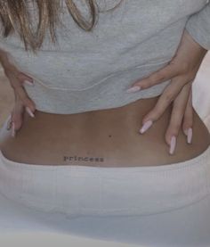 a woman with her hands on the back of her stomach and writing that reads princess