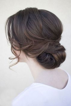 a woman with her hair in a low bun