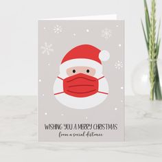 a christmas card with a santa face wearing a mask