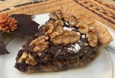 a piece of chocolate pie with walnuts on top