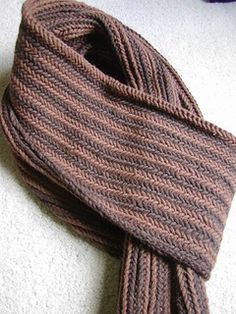 a brown knitted scarf laying on the floor