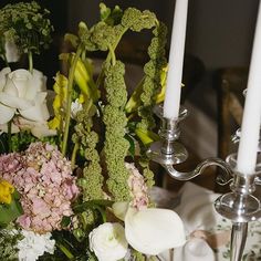 flowers and candles are sitting on a table