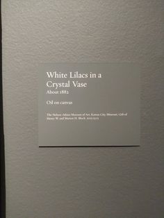 a sign on the wall that says white lilas in a crystal vase about 1853