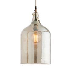 a clear glass pendant light hanging from a ceiling fixture with a bulb on the end