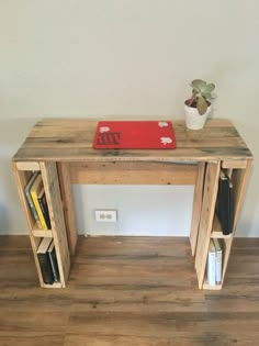 a wooden table with books and a laptop on it