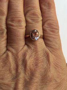 An ample size 8, this stamped 10K signed BBJ ring is made in Thailand and dates to the 1990s.  The stone is a really pretty faceted oval cut faceted pale lilac (almost pink to me) stone that I was told by the owner is morganite. I have not personally tested the stone, and if I didn't know better I would've said it was a pale amethyst. That said, this is not glass, and it is a real gem stone. This ring is in very good, pre-owned vintage condition, no damage or repair and ready to wear.  Just lovely!  See photos and zoom in for size and more.  Pictures tell the story. Please make sure to view all the photos carefully and zoom in for details.  Don't hesitate to reach out if you have any questions about this or any other of my items. Classic Oval Faceted Topaz Ring, Oval Amethyst Ring With Diamond Cut, Oval Diamond Cut Amethyst Ring, Oval Faceted Rings For Anniversary, Heirloom Oval Faceted Ring, Oval Faceted Topaz Anniversary Ring, Oval Solitaire Topaz Ring In Rose Gold, Rose Gold Morganite Ring, Pale Lilac