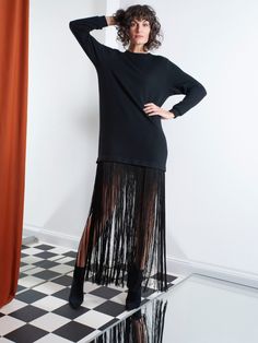 High-necked fine knit dress with detachable extra-long fringes at the hem line. Can be worn as a maxi dress, a mini dress or as a maxi pullover. Composition: 100% Wool Material 2: 100% Polyester Spring Maxi Dress With Fringe, Spring Fringe Maxi Dress, Evening Maxi Dress With Tassels, Long Sleeve Maxi Dress With Tassels For Party, Party Long Sleeve Maxi Dress With Tassels, Elegant Long Sleeve Maxi Dress With Tassels, Spring Evening Maxi Dress With Fringe, Chic Maxi Length Dresses With Tassels, Chic Maxi Dress With Tassels