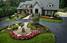 a large house with landscaping in the front yard and driveway on both sides, surrounded by lush greenery