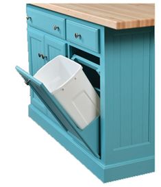 a blue kitchen island with a trash can in it