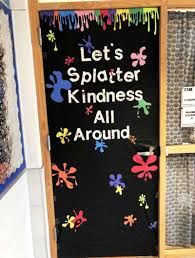 a sign that says let's splatter kindness all around in front of a display case