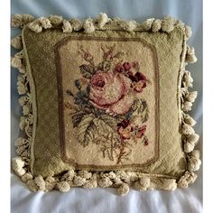 an embroidered pillow with flowers on it