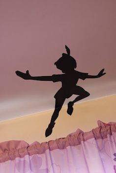 the silhouette of a girl jumping up into the air with her arms stretched out in front of her