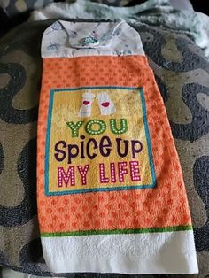 an orange and white towel with the words you spice up my life written on it