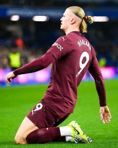 a female soccer player sitting on the ground