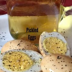 pickled eggs on a plate next to a jar of honey