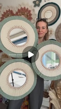 a woman holding four circular mirrors in front of her face