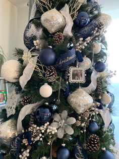 a christmas tree decorated with blue and white ornaments