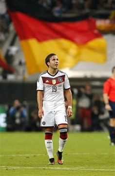 a soccer player is standing on the field