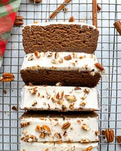 three slices of cake on a cooling rack with pecans and cinnamons around them