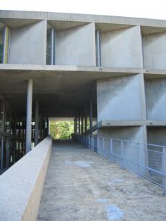 an empty concrete building with stairs leading up to it