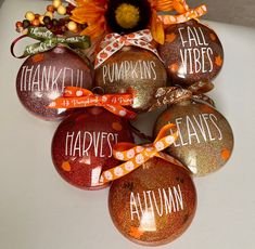 six hand painted pumpkins with words on them