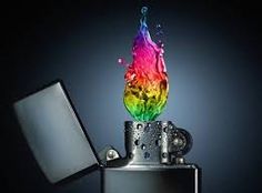 a rainbow colored liquid splashing out of a black metal flask on top of a lighter